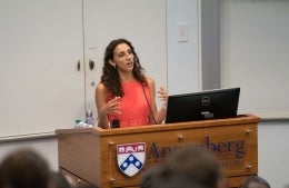 Kelly Diaz standing at an Annenberg podium speaking