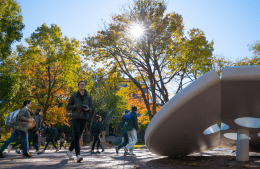 Penn button 1920x1250.png view of students walking past a white modern sculpture of a button on a sunny day