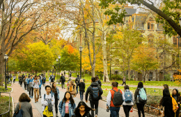 Fall trees line Locust Walk as Penn students walk across campus, photo credit Eric Sucar / University of Pennsylvania