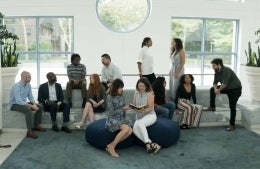 2019 cohort of PhD students gathered informally in Plaza lobby with Dean Jackson