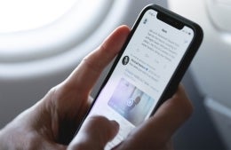 Closeup of hands holding a phone and scrolling through Twitter, photo credit Marten Bjork / Unsplash