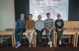20190426-DSC09787 1920x1250 CROP smaller image size.jpg Group of five graduate students sitting at the Graduate Student Symposium