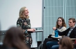 Amy Jordan smiling as she delivers lecture