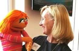 Amy Jordan poses for photo with muppet