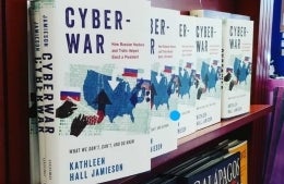 Five copies of Cyber War on bookshelf with the cover facing out