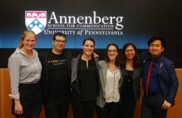 Graduate students posing in front of Annenberg School for Communication Logo