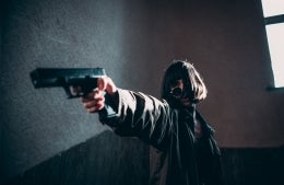 Photo of an actor holding a firearm, photo credit Elijah O'Donnell / Unsplash