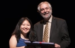One award recipient poses with Dean Michael X. Delli Carpini while receiving award from him.