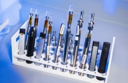 This image depicted a test tube rack that had been stocked with examples of various electronic cigarettes; Photo by CDC on Unsplash