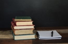 stack of books next to a notepad; Photo by Debby Hudson on Unsplash