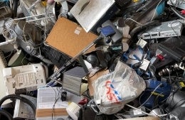 large pile of e-waste; Photo Credit: John Cameron on Unsplash