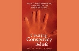 Cover of "Creating Conspiracy Beliefs". A handprint is displayed against a blank background.