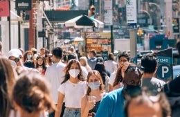 Crowd of masked people in city