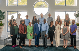 15 graduate students pose with Dean John L. Jackson and Associate Dean for Graduate Studies John Jemmott in the Annenberg Plaza