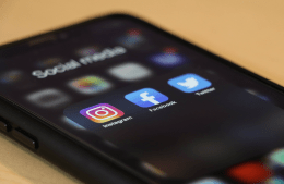 Social media icons on iPhone screen. From L to R: Instagram, Facebook, Twitter.