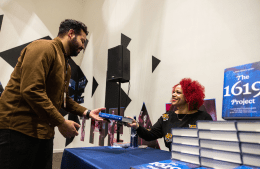 Nikole Hannah-Jones hands a "The 1619 Project" book to a lecture attendee