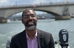 Deen Freelon with water and a bridge behind him