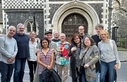 A group of people standing in front of an old building