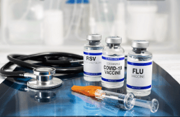 Bottles of vaccine for Influenza Virus, Respiratory Syncytial virus and Covid-19 for vaccination. Flu, RSV and Sars-cov-2 Coronavirus vaccine vials over Radiography pulmonar with stethoscope