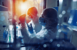 Two scientists in a lab hold test tubes