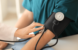 A person having their blood pressure taken with a blood pressure cuff