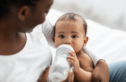 infant drinking from a bottle