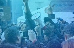 crowd of people protesting, photo credit iStock / Alexander Gouletas
