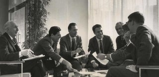 George Gerbner seated amid six other male faculty members