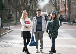Three students standing on Locust Walk