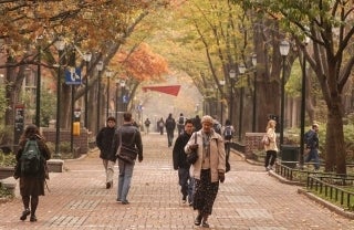 Many people walking along Locust Walk in fall