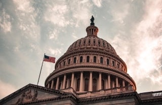 Dome of U.S. Capitol Building against a cloudy sky, photo credit Kyle Mills/Unsplash