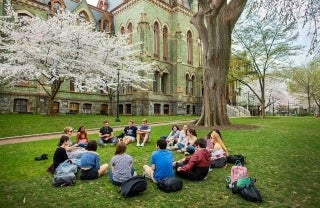 Penn students gather on lawn in front of College Hall, photo credit Eric Sucar / University of Pennsylvania