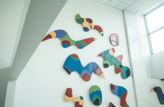 view of colorful abstract art on a white wall inside Annenberg building