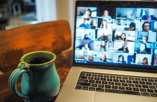 coffee mug on table next to laptop with video chat meeting, photo credit credit Chris Montgomery / Unsplash