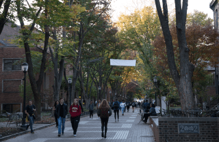 students walking down Locust Walk on a sunny day 