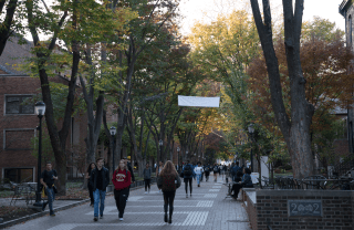 students walking down Locust Walk on a sunny day