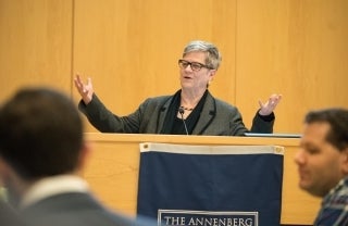 Kathleen Hall Jamieson standing at a podium with her hands spread apart, speaking