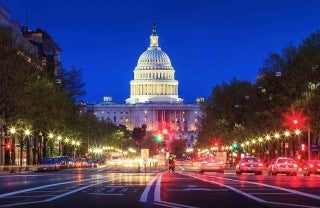 Photo in Washington D.C. of traffic with the United States Capitol in the back at night