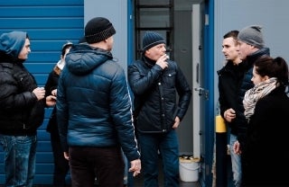 Group of people standing around smoking, photo credit @abiismail / Unsplash