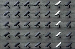 Surveillance cameras arranged in a 5x7 array, photo credit Lianhao Qu / Unsplash