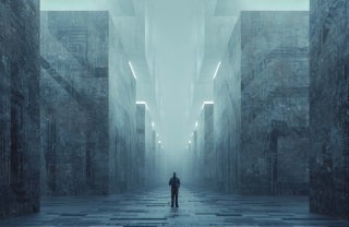 Abstract photo of an individual standing in a deserted street with tall buildings around