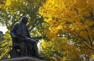 View of Ben Franklin statue from ground level with trees in the backgrounds, photo credit Scott Spitzer / University of Pennsylvania