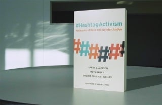a copy of HashtagActivism stands on a table, photo credit Brooke Foucault Welles / Twitter