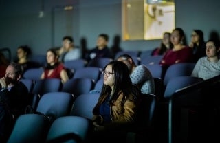 Photo of students watching a presentation