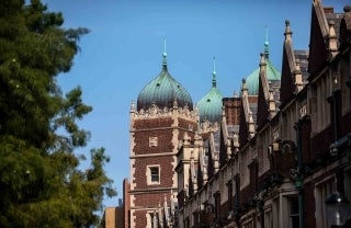 photo of red buildings on right and trees on left, photo credit Eric SucarUniversity of Pennsylvania