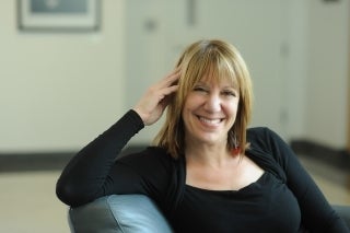 Barbie Zellizer, Ph.D., seated and smiling for the picture