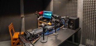 Soundproofed room with audio studio equipment on a desk