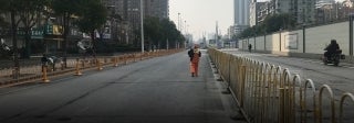 Man walking down empty street in Wuhan, China