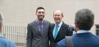 David Eisenhower posing for photos with one of his advisees at graduation