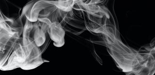 Black and white image of smoke that is flowing across the image. The smoke has a wave-like form. Photo by Pascal Meier on Unsplash.
